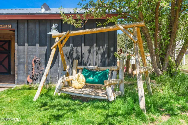 an aerial view of a house with swimming pool and porch