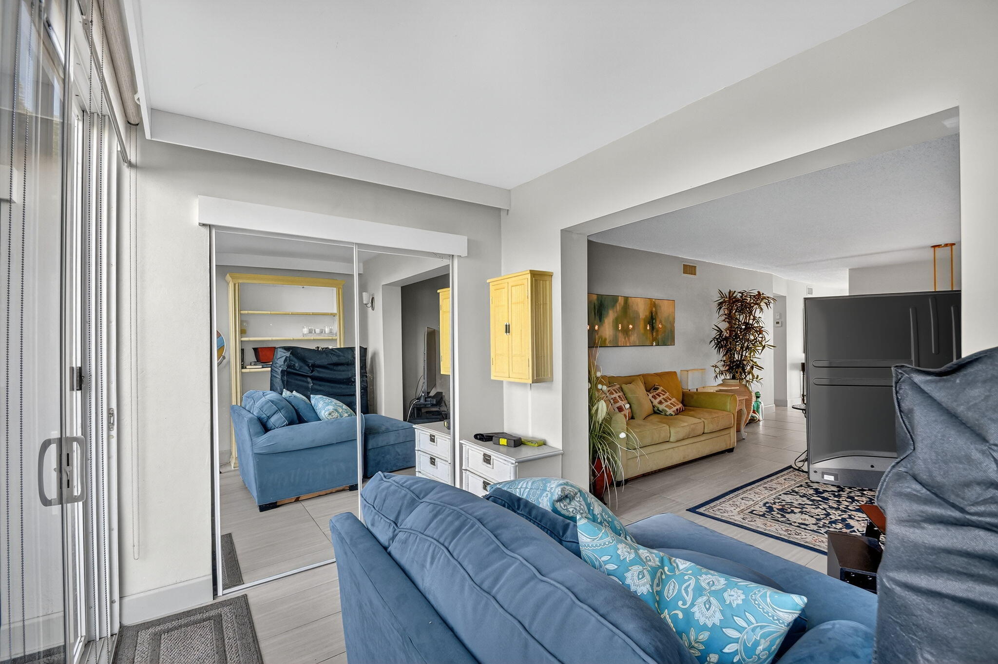 2400 Northeast 1st Lane, Unit 102 Boynton Beach, FL 33435 - Photo 15 of 44 a bedroom with furniture and a flat screen tv