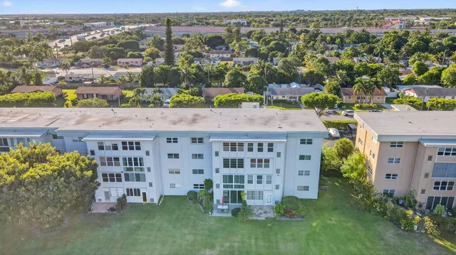 an aerial view of a house with a yard and lake view