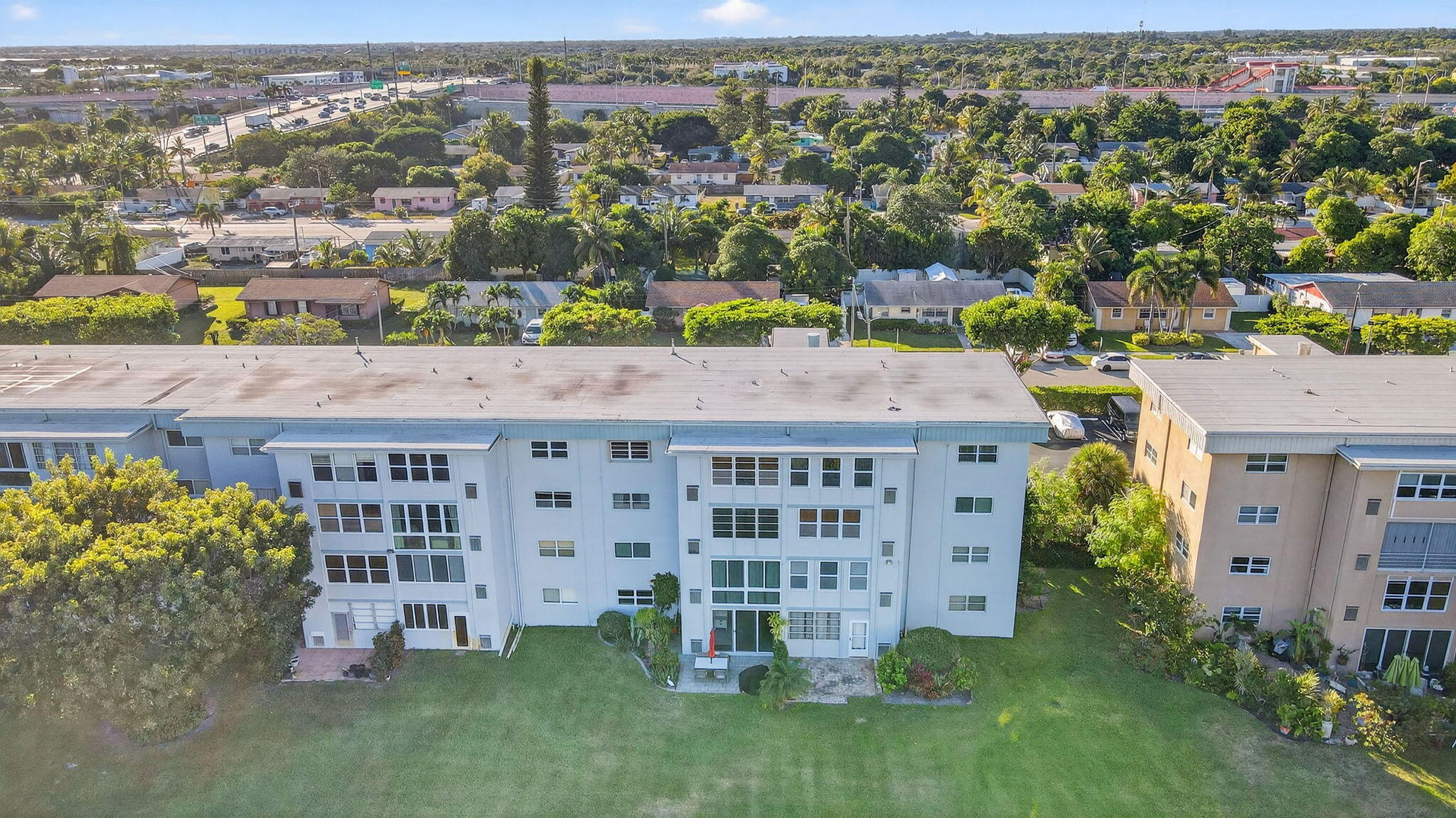 2400 Northeast 1st Lane, Unit 102 Boynton Beach, FL 33435 - Photo 38 of 44 an aerial view of residential building with outdoor space and seating