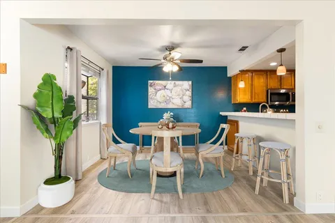 a dining room with furniture and window