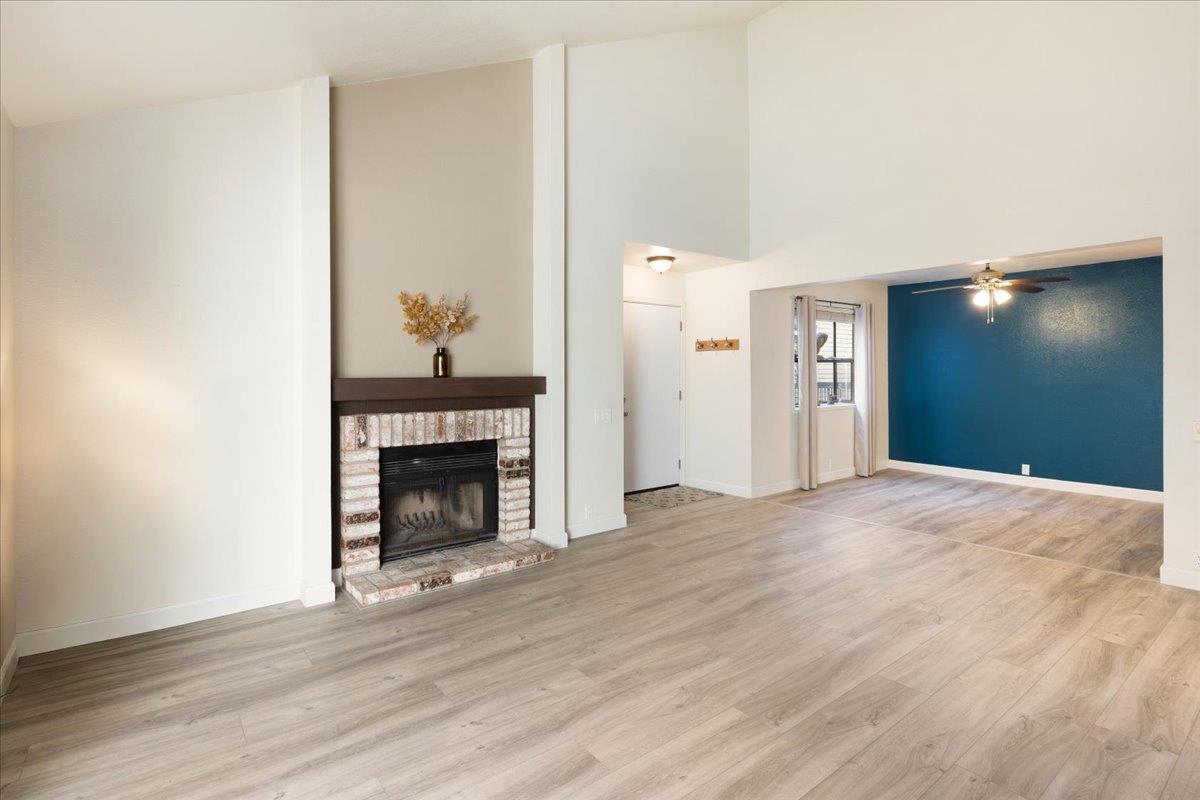 2280 Hurley Way, Unit 32 Sacramento, CA 95825 - Photo 11 of 24 a view of an empty room with wooden floor and a fireplace