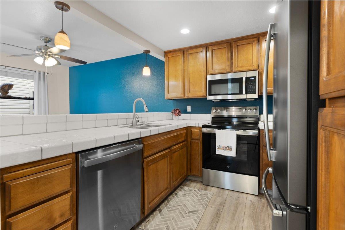 2280 Hurley Way, Unit 32 Sacramento, CA 95825 - Photo 12 of 24 a kitchen with a sink stove and microwave