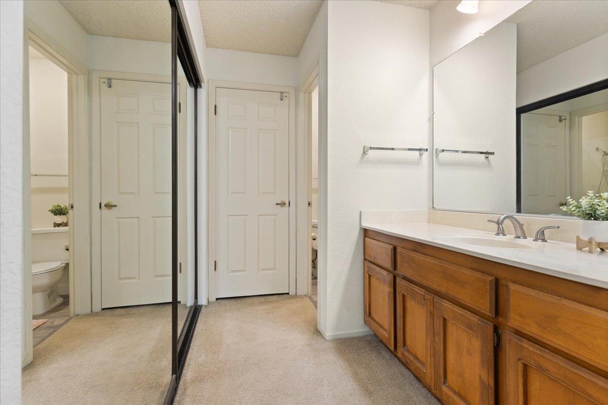 2280 Hurley Way, Unit 32 Sacramento, CA 95825 - Photo 16 of 24 a bathroom with a double vanity sink and mirror