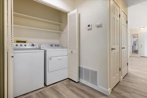 a utility room with cabinets washer and dryer