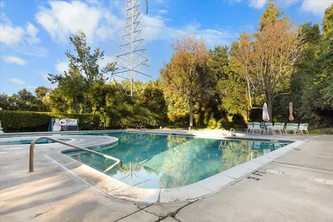 a view of a swimming pool with a lounge chairs