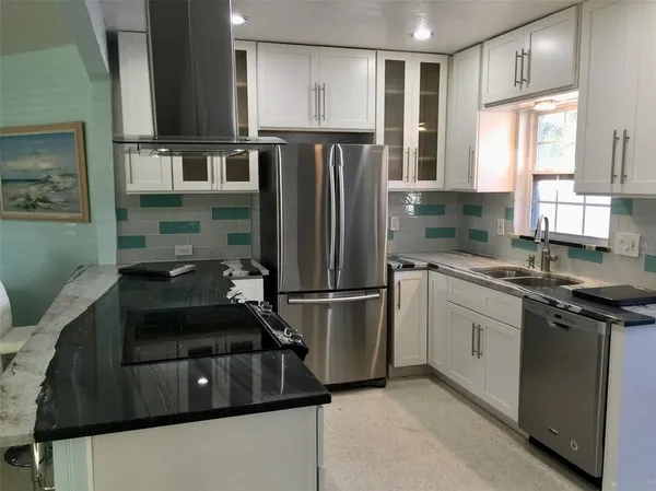 a kitchen with a refrigerator and a sink