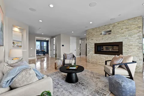 a living room with furniture a rug and a fireplace