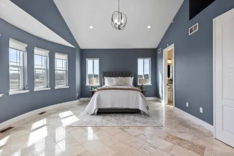 a spacious bedroom with a large bed and a window