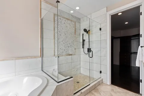 a bathroom with a shower and a tub