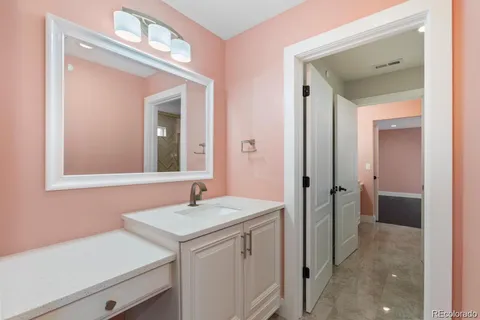 a bathroom with a sink vanity and a mirror