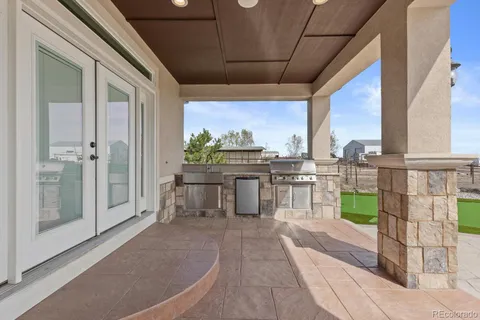 a view of a chairs and table in the balcony