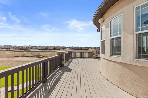 a view of a balcony with wooden floor and city view