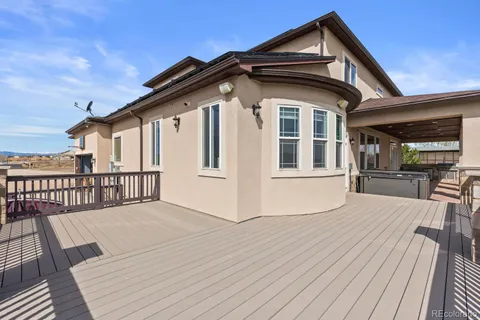 a view of a house with wooden deck