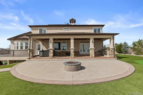 a view of a house with pool and chairs