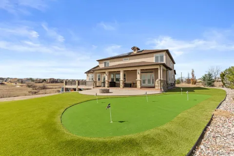 a view of house with swimming pool outdoor seating