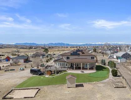 an aerial view of a building with garden space and ocean view