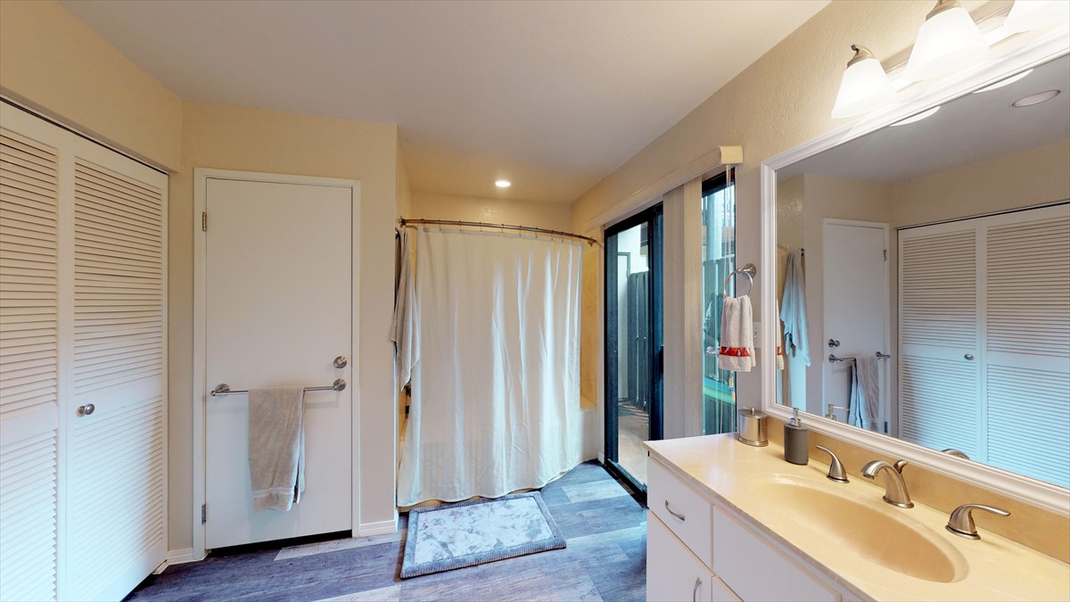 3920 Wyllie Road, Unit 6A Princeville, HI 96722 - Photo 13 of 19 a bathroom with a sink and a mirror