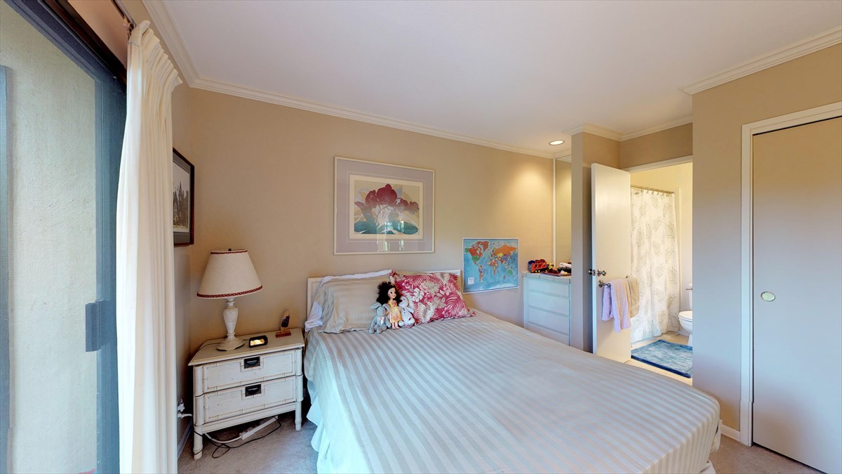 3920 Wyllie Road, Unit 6A Princeville, HI 96722 - Photo 14 of 19 a spacious bedroom with a bed and wooden floor