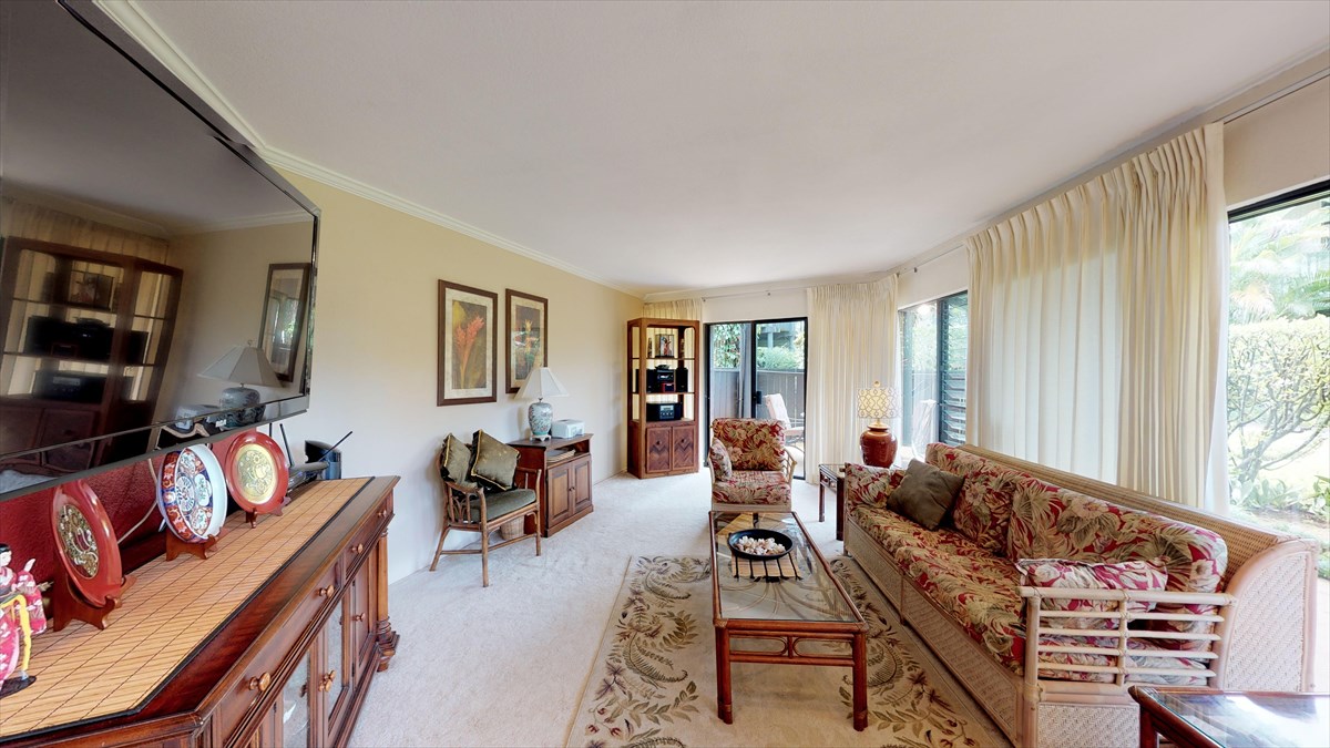 3920 Wyllie Road, Unit 6A Princeville, HI 96722 - Photo 2 of 19 a living room with furniture and a flat screen tv