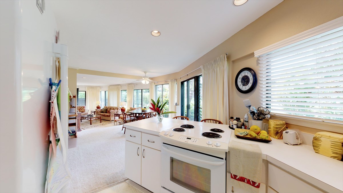3920 Wyllie Road, Unit 6A Princeville, HI 96722 - Photo 10 of 19 a kitchen that has a stove a table and chairs in it