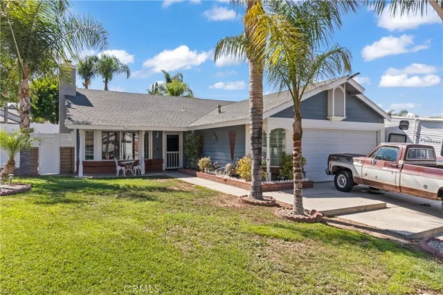 a view of a house with swimming pool and sitting area