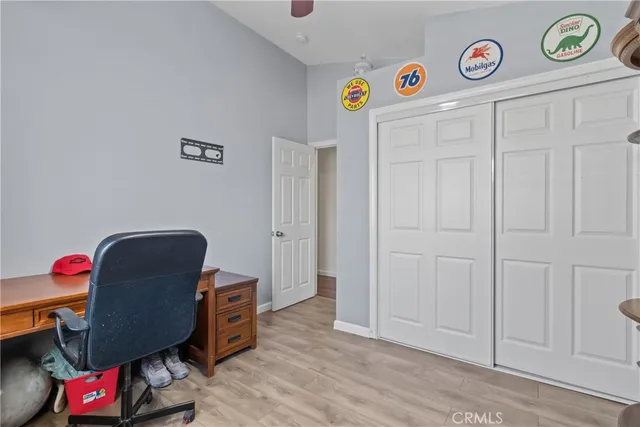 a view of a workspace with furniture and wooden floor