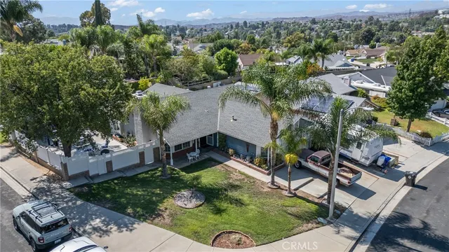 an aerial view of a house with a yard and lake view