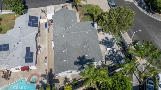 an aerial view of a house with a yard and a water fountain
