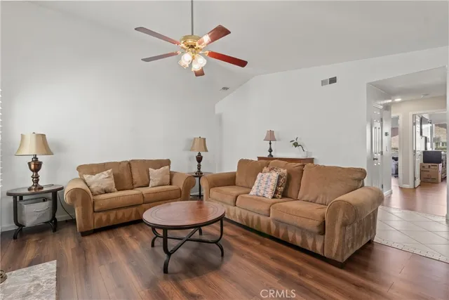 a living room with furniture a view of bedroom and a couch