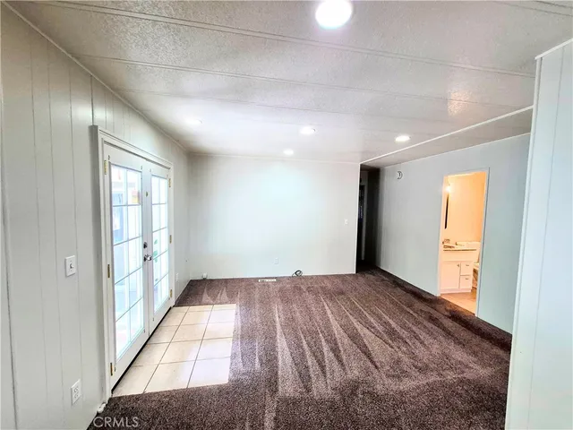 a kitchen with granite countertop stainless steel appliances a refrigerator a sink and a stove