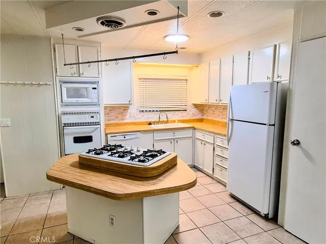 a view of a room with wooden floor and windows