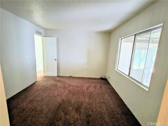 a bathroom with a granite countertop sink a toilet and a mirror