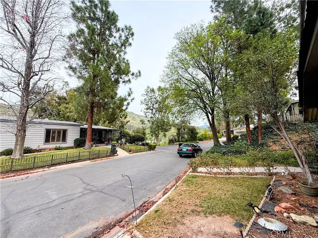 a view of a yard with cars