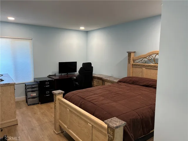 a bedroom with a bed and a television