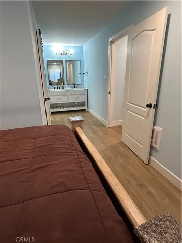 a view of kitchen with sink and refrigerator