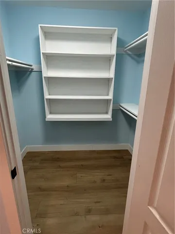 a view of walk in closet with empty racks