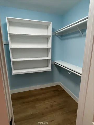 a view of walk in closet with empty racks