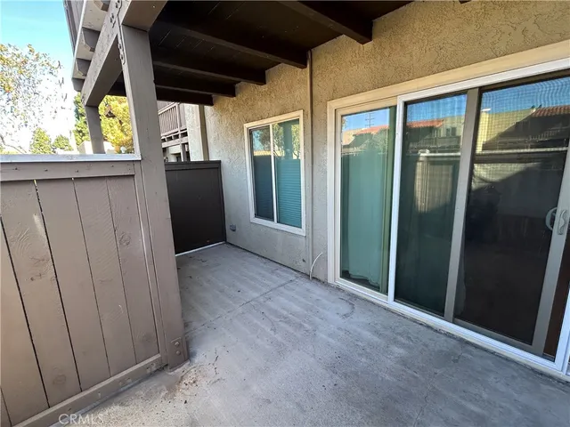 an empty room with window and hardwood