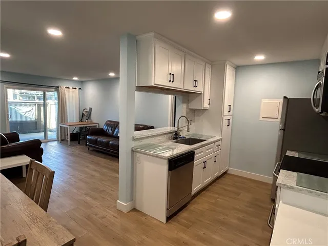 a kitchen with sink stove and refrigerator