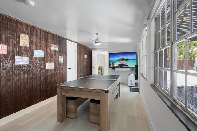 a kitchen with a table chairs refrigerator and cabinets