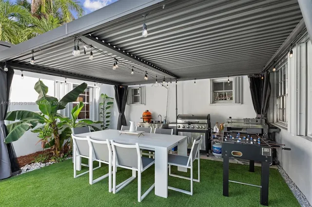 a view of a backyard with furniture and garden