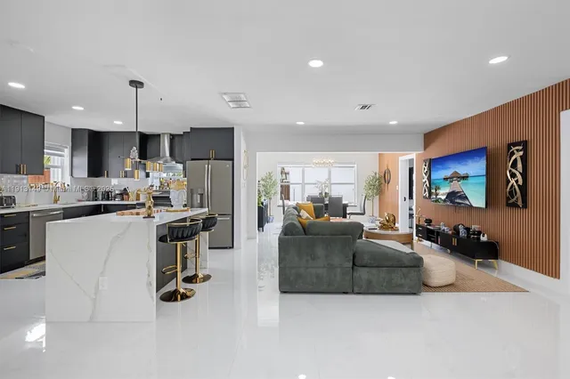 a living room with furniture and kitchen view