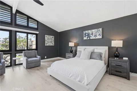 a bedroom with a bed and a large window