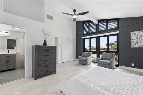 a bedroom with a bed next to a large window