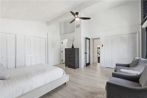 a spacious bedroom with a bed and a couch