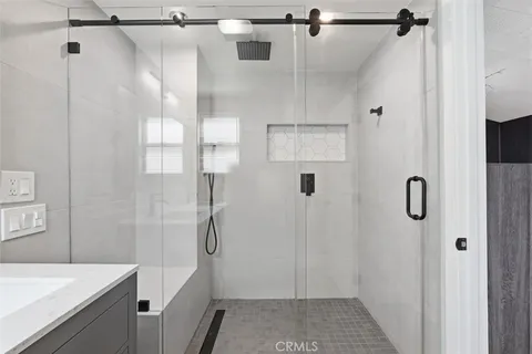 a bathroom with a shower and a sink