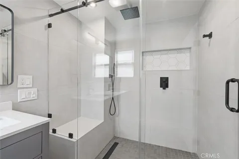 a bathroom with a shower and a sink