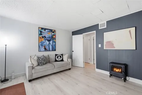 a living room with furniture and a painting on the wall