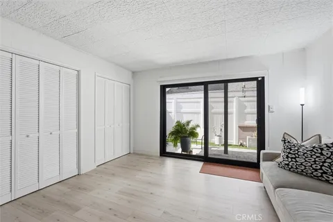 a living room with furniture and a large window with outer view